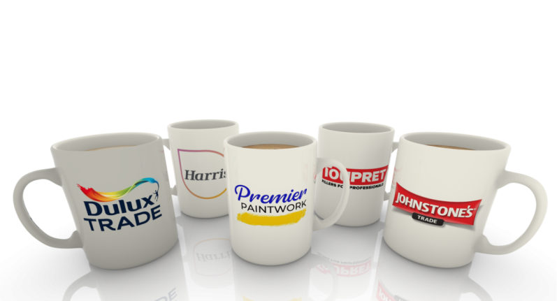 Five coffee mugs with various logos and designs, arranged in a group.